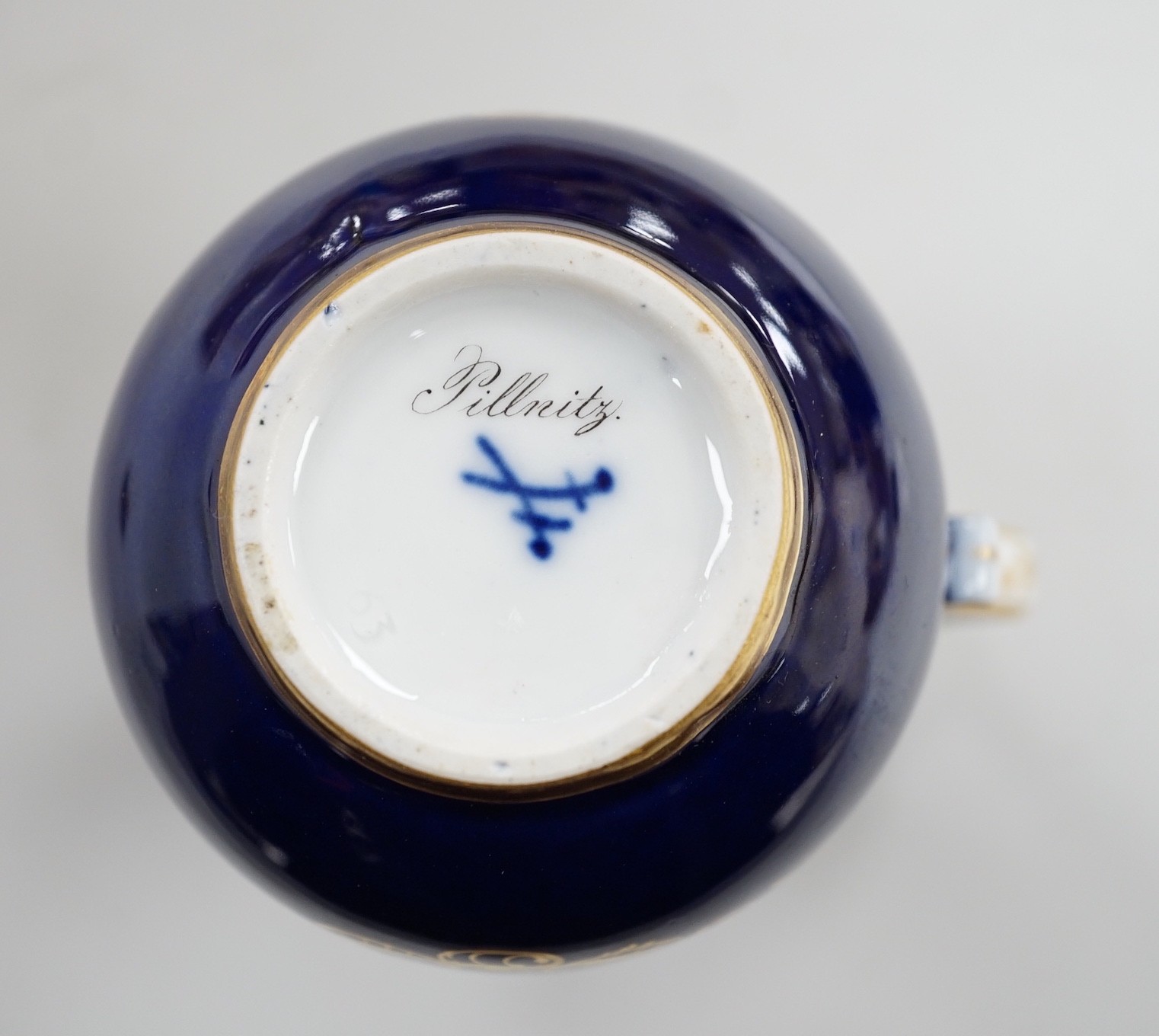 A small 19th century Meissen cobalt blue ground jug and cover, 9.5cm tall